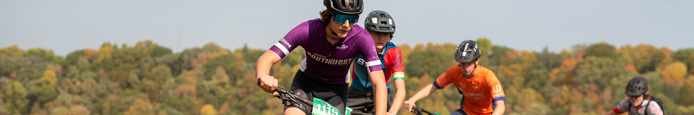 Mountain bikers with colorful trees in background at Mount Kato